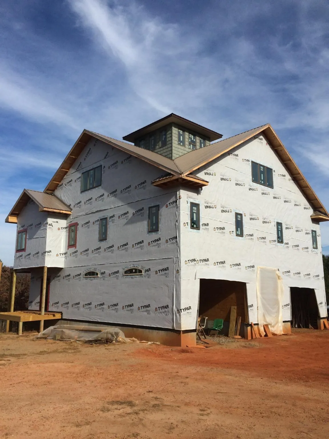 New two story house under construction with a cupola and gabled roofs in Bumpus Mills